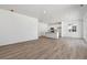 Open concept living room and kitchen featuring plank-style flooring, recessed lighting, and stainless appliances at 9672 Cathay St, Commerce City, CO 80022