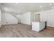 Open concept living room and kitchen featuring plank-style flooring, recessed lighting, and stainless appliances at 9672 Cathay St, Commerce City, CO 80022