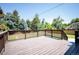 Expansive wooden deck offering serene backyard views, perfect for relaxing or entertaining outdoors at 6705 E Jewell Ave, Denver, CO 80224