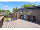 Spacious wooden deck perfect for outdoor entertaining with access to the backyard and upper floor at 6705 E Jewell Ave, Denver, CO 80224