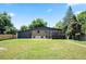 Large backyard featuring a spacious lawn and a wooden deck, perfect for outdoor living at 6705 E Jewell Ave, Denver, CO 80224