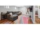 Finished basement featuring a large sectional sofa, wood floors, and a decorative rug at 6705 E Jewell Ave, Denver, CO 80224