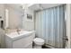 Bright bathroom featuring a sink, toilet, and shower with a decorative curtain at 6705 E Jewell Ave, Denver, CO 80224