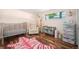 Charming Bedroom with a crib, zebra rug, and a bright window at 6705 E Jewell Ave, Denver, CO 80224