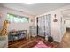 Charming bedroom with hardwood floors, a window with green views, and ample storage space at 6705 E Jewell Ave, Denver, CO 80224
