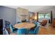 Open-concept living with a stone fireplace, modern furniture, and a round dining table with seating for six at 6705 E Jewell Ave, Denver, CO 80224