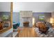 Inviting living room with a stone fireplace, wood floors, and a mid-century modern chair at 6705 E Jewell Ave, Denver, CO 80224