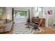 Inviting living room with stylish furniture, including an Eames lounge chair and modern decor at 6705 E Jewell Ave, Denver, CO 80224
