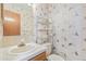 Cozy half bathroom featuring white fixtures and patterned wallpaper at 1350 S Idalia St # G, Aurora, CO 80017
