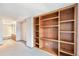 Carpeted bedroom with a built-in bookshelf and access to the en-suite bathroom at 1350 S Idalia St # G, Aurora, CO 80017