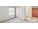 Carpeted bedroom with a window, closet, and access to the en-suite bathroom at 1350 S Idalia St # G, Aurora, CO 80017