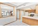 Bright kitchen with white tiled floors and a breakfast bar, open to the living area for easy entertaining at 1350 S Idalia St # G, Aurora, CO 80017