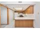 Bright kitchen with white appliances, tile flooring, wood cabinets, and a breakfast bar area at 1350 S Idalia St # G, Aurora, CO 80017