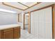 Open kitchen area with white tiled floors, natural wood cabinets, and access to the laundry room at 1350 S Idalia St # G, Aurora, CO 80017