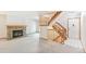 Spacious living room with a stone fireplace and wood mantel, next to the staircase at 1350 S Idalia St # G, Aurora, CO 80017