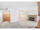 Spacious living room with a stone fireplace, neutral carpet, and ample natural light at 1350 S Idalia St # G, Aurora, CO 80017
