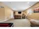 Spacious basement Gathering room with comfortable seating and TV at 12551 Tamarac St, Thornton, CO 80602