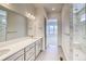 Well-lit bathroom with double vanity, marble countertops, and a luxurious walk-in shower at 22097 E Rockinghorse Pkwy, Aurora, CO 80016