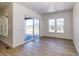 Bright dining area with light wood floors, large windows, and sliding glass door to outdoor patio at 22097 E Rockinghorse Pkwy, Aurora, CO 80016