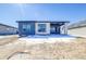 Rear exterior view featuring a modern design with large windows and a covered patio at 22097 E Rockinghorse Pkwy, Aurora, CO 80016