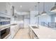 Bright open kitchen with modern appliances, white countertops, and a large kitchen island at 22097 E Rockinghorse Pkwy, Aurora, CO 80016