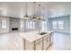 Bright kitchen with a large island, stainless steel sink, and open to the living area at 22097 E Rockinghorse Pkwy, Aurora, CO 80016