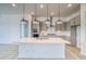 Bright kitchen with a large island, pendant lights, and an open layout to the living area at 22097 E Rockinghorse Pkwy, Aurora, CO 80016