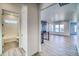 View from hallway into the bright living room with a fireplace, light wood floors, and an adjacent bathroom at 22097 E Rockinghorse Pkwy, Aurora, CO 80016