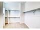 Bright walk-in closet with neutral carpeting, rod and shelves offering abundant storage space at 22097 E Rockinghorse Pkwy, Aurora, CO 80016