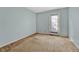 Simple bedroom with carpet, door and window at 16920 E Berry Ave, Centennial, CO 80015