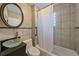 Bathroom with a glass bowl sink, tiled walls, and a shower with a curtain at 3613 Julian St, Denver, CO 80211