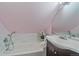 Bright bathroom with white bathtub, marble backsplash, and an updated vanity with a large mirror at 3613 Julian St, Denver, CO 80211