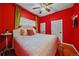 Cozy bedroom with a queen bed, ceiling fan, and hardwood floors at 3613 Julian St, Denver, CO 80211