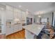 Bright kitchen with stainless steel appliances and white cabinets at 3613 Julian St, Denver, CO 80211