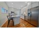 Bright kitchen with stainless steel appliances and white cabinets at 3613 Julian St, Denver, CO 80211