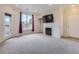 Spacious living room featuring a fireplace, access to a balcony and natural light at 19019 E Warren Dr # H206, Aurora, CO 80013