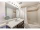 Well-lit bathroom with a shower-tub combination and vanity with dark cabinetry at 4760 S Wadsworth Blvd # 302, Littleton, CO 80123