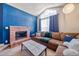 Bright living room with cozy fireplace, and oversized sectional couch by a large window at 4760 S Wadsworth Blvd # 302, Littleton, CO 80123