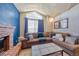 Comfortable living room featuring a brick fireplace and a large window at 4760 S Wadsworth Blvd # 302, Littleton, CO 80123