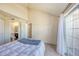 Cozy bedroom with a sliding glass door leading to a balcony and an attached bathroom at 4760 S Wadsworth Blvd # 302, Littleton, CO 80123