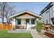 Charming bungalow features an inviting front porch, wood detail, and a well-maintained yard at 4401 Vrain St, Denver, CO 80212