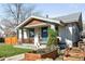 Charming bungalow features a covered front porch with tidy landscaping and a walkway at 4401 Vrain St, Denver, CO 80212