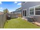 Backyard with artificial grass, grill, wooden fence, and patio area at 11062 Gaylord St, Northglenn, CO 80233