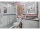 Bathroom features a glass shower, floral wallpaper, and modern vanity with grey countertop at 11062 Gaylord St, Northglenn, CO 80233