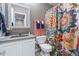 Bathroom featuring a floral shower curtain, vanity and mirror at 11062 Gaylord St, Northglenn, CO 80233