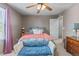 Bedroom featuring plush carpet, a ceiling fan, windows with blinds, and decorative furniture at 11062 Gaylord St, Northglenn, CO 80233