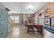 Open-concept dining area featuring wood floors and a modern table set, adjacent to the staircase and kitchen at 11062 Gaylord St, Northglenn, CO 80233