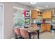 Cozy kitchen with an adjacent dining area, featuring wooden cabinetry and stainless steel appliances at 11062 Gaylord St, Northglenn, CO 80233