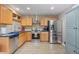 Bright kitchen features stainless steel appliances, wooden cabinetry, and modern countertops at 11062 Gaylord St, Northglenn, CO 80233