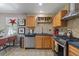 Well-designed kitchen with stainless steel appliances and cabinetry, perfect for cooking and entertaining at 11062 Gaylord St, Northglenn, CO 80233